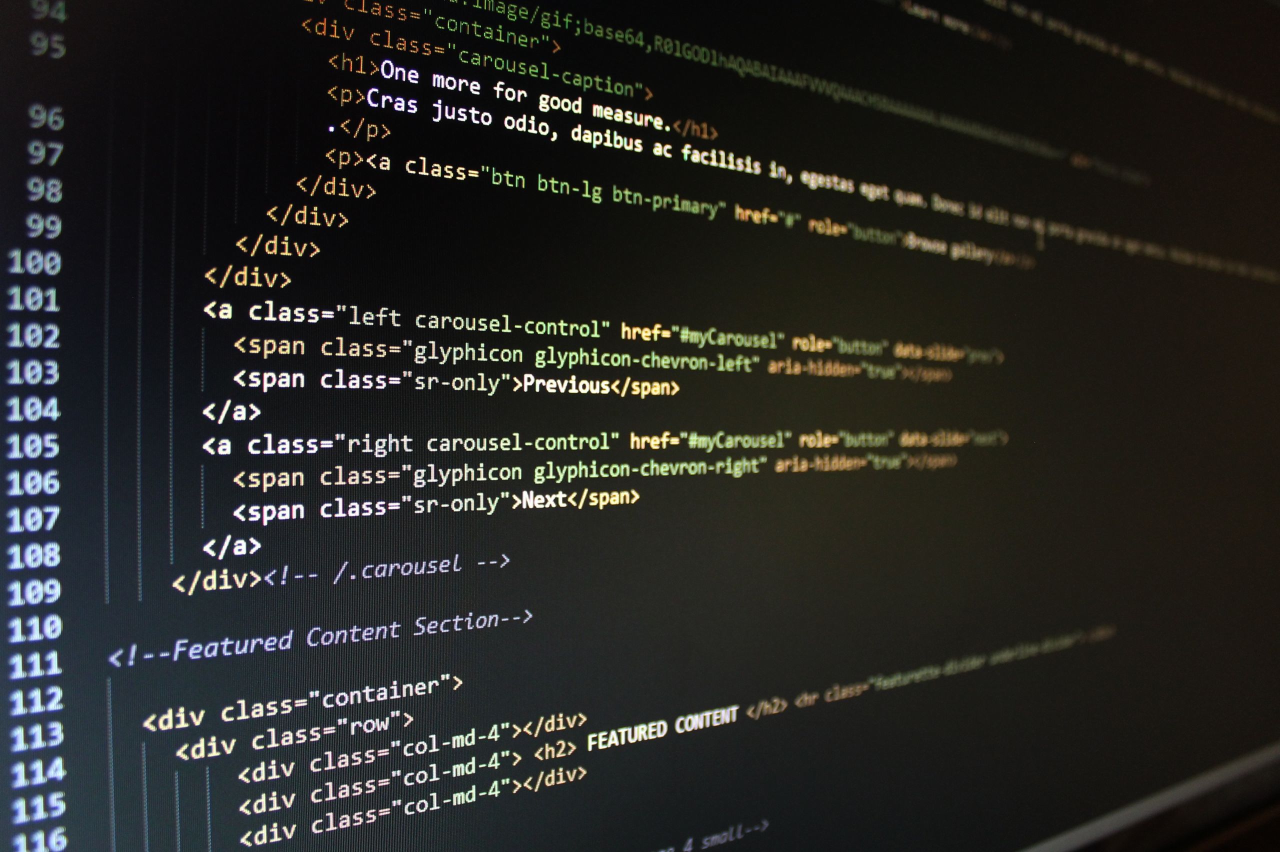 Close-up of HTML code displayed on a computer monitor, showcasing web development.